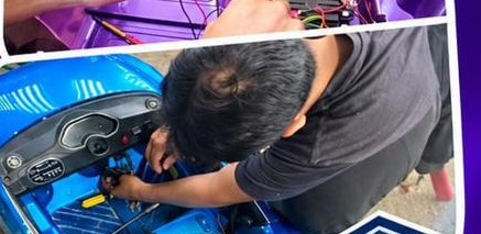 Technician servicing a blue kids ride-on car